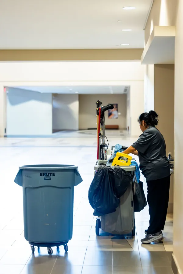 Janitorial staff servicing a common area corridor